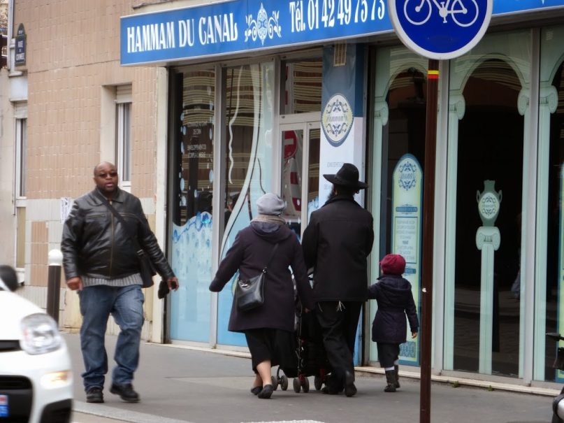 A Jewish family walks down a street in northeastern Paris. RNS photo by Elizabeth Bryant 