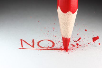 A red pencil and the word "NO."