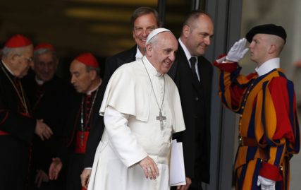 A Swiss Guard salutes as Pope Francis and cardinals leave a meeting in the synod hall at the Vatican on Thursday (Feb. 20). The pope asked the world's cardinals and those about to be made cardinals to meet at the Vatican Feb. 20-21 to discuss the church's pastoral approach to the family. Photo by Paul Haring, courtesy of Catholic News Service