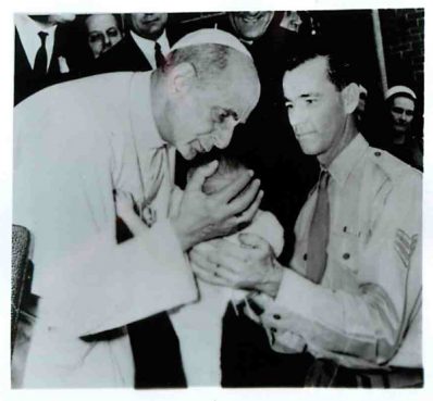 (1970) During a visit in Sydney, Pope Paul bends to kiss a baby held by his soldier father at the Royal Alexandra Hospital for Children in the Australian city. Religion News Service file photo