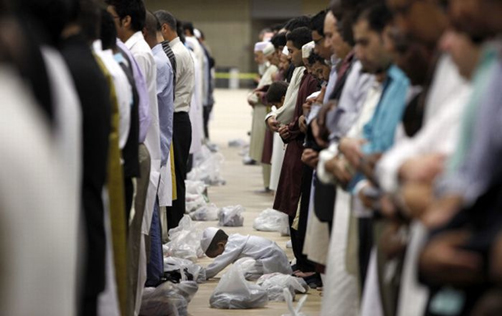 (RNS) A young boy prays alongside Muslim men at an Eid al-Fitr observance at the U.S. Embassy to Indonesia in Jakarta. Photo courtesy U.S. Embassy to Indonesia.