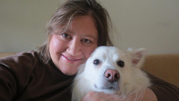 Amy Tracy is a writer for global mission at David C Cook in Colorado Springs. She lives with her adopted family -- two best friends, four children, four dogs, two horses, two hamsters and one disagreeable cat. Amy is pictured here with her dog, Wrecks. Photo courtesy of Amy Tracy