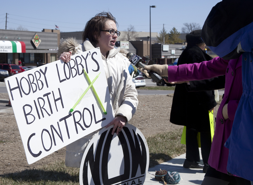 Amy Bell, Kansas state coordinator for National Organization for Women, stands in front of the Hobby Lobby store in Mission, Kan. on Tuesday (March 25) and tells reporters, "It's a little scary to me," regarding the company's stance that they should not be forced by the government to provide coverage to employees for those forms of contraception they consider abortifacient. RNS photo by Sally Morrow