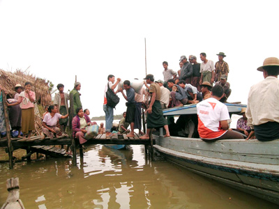 Teams from the Christian relief agency World Vision distribute food aid to villages in Myanmar by boat because many roads were washed away by Cyclone Nargis, which claimed more than 140,000 lives when it roared ashore on May 1, 2008. Religion News Service photo courtesy of Wah Eh Htoo/World Vision