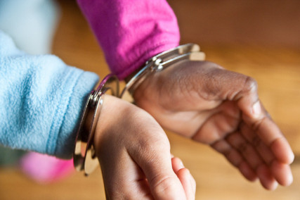 Handcuffed Girls. Photo courtesy Stephen Depolo via Flickr Creative Commons.