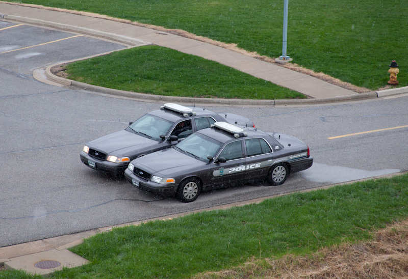 Two Overland Park Police cars patrol the Jewish Community Center of Greater Kansas City campus on April 14 in Overland Park, Kan., one day after Frazier Glenn Cross shot and killed 2 men in the parking lot. Religion News Service photo by Sally Morrow