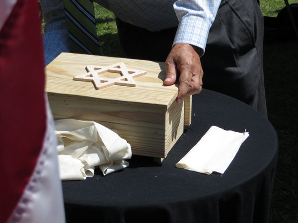 (RNS) a member of Beth El Synagogue in Durham, N.C., built a plain pine box with a Star of David to contain the ashes of Holocaust victims that were recovered from the Dachau death camp at the end of World War II. RNS photo by Yonat Shimron.