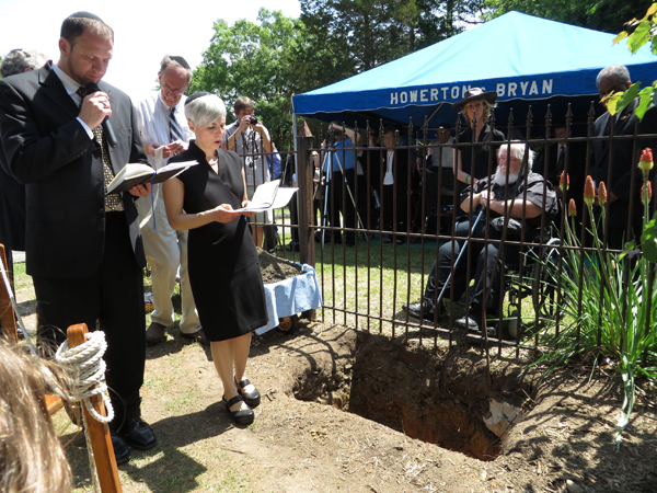 (RNS) Rabbi Daniel Greyber of Beth El Synagogue in Durham, N.C., and Rabbi Jen Feldman of Kehillah Synagogue in Chapel Hill, N.C., lead a burial service for ashes of Holocaust victims recovered at the end of World War II at the Dachau death camp in Germany. RNS photo by Yonat Shimron.