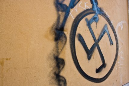 Swastika painted on a wall.