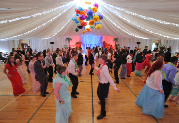 Young adults maintain a respectable distance as they dance during a Mormon prom at The Church of Jesus Christ of Latter-day Saints in Morristown, N.J.  The goal of this prom is to practice modesty and keep costs low. It encourages wholesome conduct and dress and is free to attend. Photo by Tony Kurdzuk, courtesy of The Star-Ledger