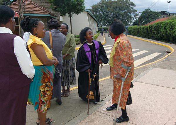 Pastor Dawn Gikandi, center, speaks with her mother, Purity, right, alongside some of the women at the Presbyterian Church of East Africa (PCEA) Bahati Martyrs' Church in Nairobi's Eastlands area.