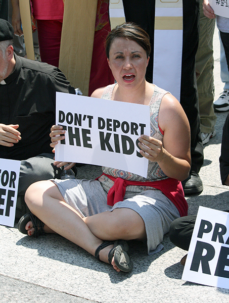 Hundreds of faith leaders and activists, including Crystal Silva-McCormick, of El Paso, Texas, participated in an immigration protest in front of the White House on July 31, 2014.