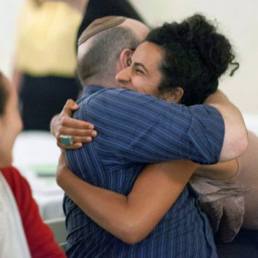 David Mattis, a Jew, embraces Sumaya Abubaker, a Muslim.