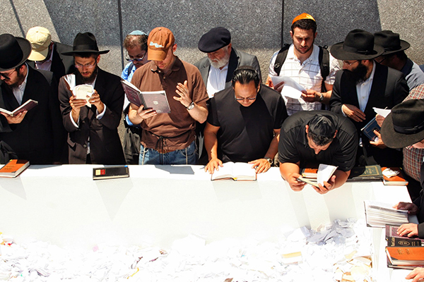 Visitors pray at the gravesite of the Lubavitcher Rebbe, Rabbi Menachem Mendel Schneerson, on June 29, 2014, at the Old Montefiore Cemetery in the Queens borough of New York. July 1 marked the 20th anniversary of Rebbe’s passing.