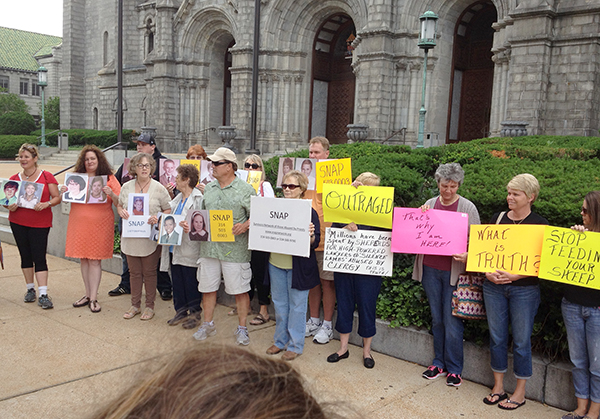 Catholics and sexual abuse survivors protest in front of the Cathedral Basilica of Saint Louis on June 11, 2014. The group gathered in response to a deposition given by St. Louis Archbishop Robert Carlson, who said he was uncertain if he knew when he was auxiliary bishop in the Archdiocese of St. Paul and Minneapolis that sexual abuse was a crime.