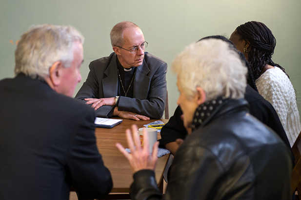 Archbishop of Canterbury Justin Welby visits with members of his congregation on April 6, 2014.