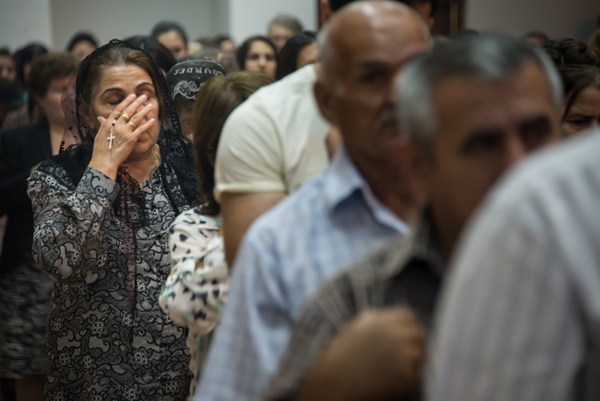 A Chaldean Catholic woman holds a rosary during a mass at Saint Joseph's Chaldean Catholic Church in the Ankawa neighborhood of Erbil, Iraqi Kurdistan on June 27, 2014. Many Iraqi Christians have fled to Erbil from other parts of the country because of violence from Muslim extremists.