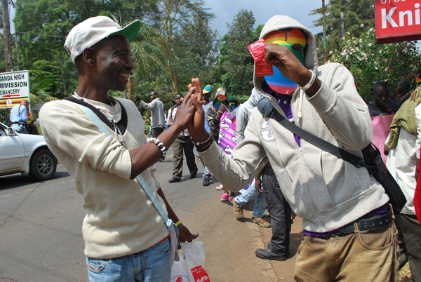 Gay rights activists share a light moment during a demonstration in Nairobi against Uganda's Anti-Homosexuality Act, 2014, in February. RNS photo by Fredrick Nzwili