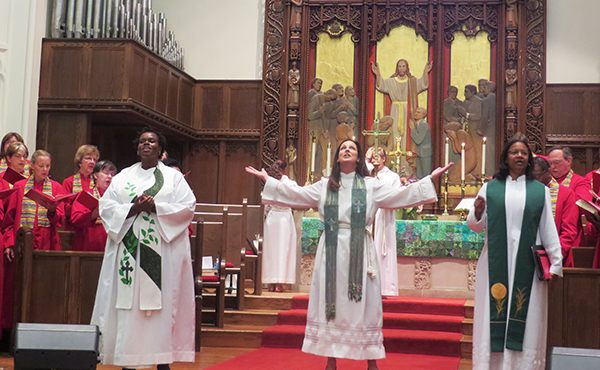 The Rev. Ginger Gaines-Cirelli, new pastor at Foundry United Methodist Church in Washington, D.C., gives the benediction on July 27, 2014. She stands with the Rev. Theresa S. Thames, associate pastor, left, and the Rev. Dawn M. Hand, executive pastor, right. Religion News Service photo by Adelle M. Banks