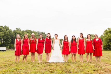 Jennifer Perron with her wedding party wearing red, as a symbolism of being drenched in the rich blood of Jesus. Photo courtesy of Jessica McIntosh Photography