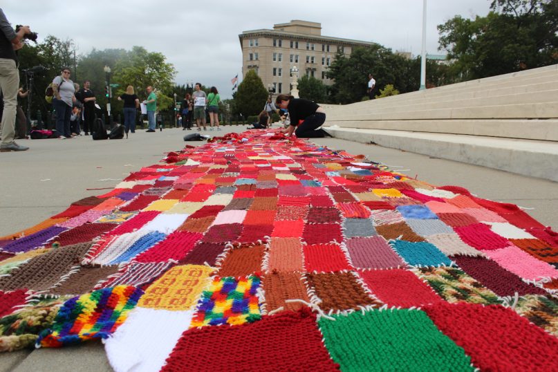 A view of a portion of the “wall” of the knitted bricks created by protesters with the Secular Coalition for America who objected to the recent Hobby Lobby decision by the U.S. Supreme Court. It was carried to the Capitol during a march by protesters on Tuesday (Sept. 9). Religion News Service photo by Adelle M. Banks
