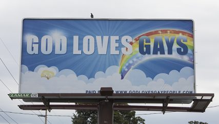 The God Loves Gays Billboard Project launched Aug. 9, 2014 on the crowdfunding site Indeigogo and a billboard reading "God Loves Gays," with a cartoon God peaking out of white fluffy clouds and a giant rainbow, went up on Sept. 8, 2014 in Topeka, Kan. Religion News Service photo by Sally Morrow