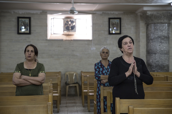 Afternoon prayer at the St. George Church in the historic Assyrian Christian town of Alqosh in the Nineveh Plain of Iraqi Kurdistan. Locals adhere to the Chaldeon Catholic religion. The town was nearly overrun by Islamic fighters earlier this summer, when Peshmerga forces withdrew their forces, abandoning the Christian town. Photo by Jodi Hilton