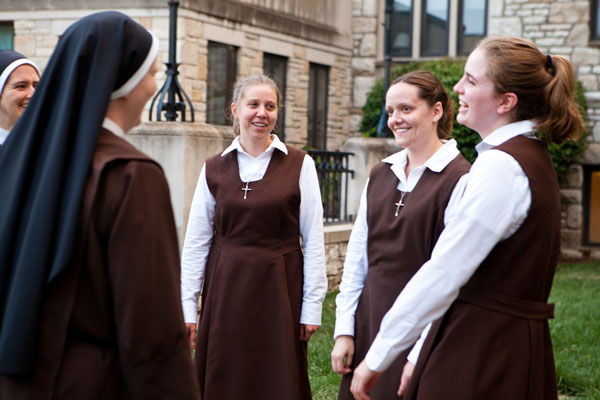 Postulants (from left center to right) Marissa Mantey, Suzie Lott and Christina Heisler talk on the grounds of the Carmelite Sisters of the Divine Heart of Jesus convent located in a suburb west of St. Louis. RNS photo by Ryan Gladstone 