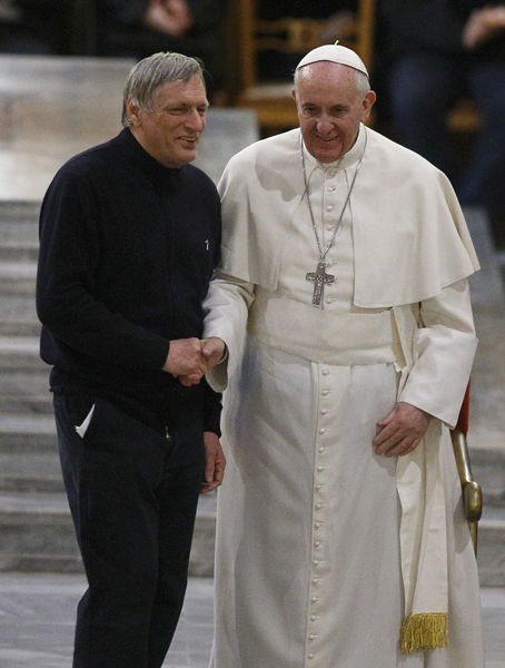 Pope Francis shakes hands with the Rev. Luigi Ciotti, founder of the Italian anti-Mafia group Libera, at Rome's Church of St. Gregory VII on March 21, 2014. Photo by Paul Haring, courtesy of Catholic News Service