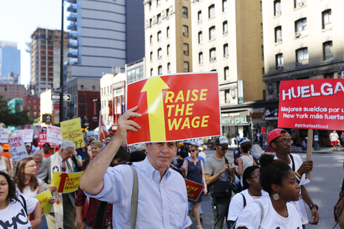 Fast food workers and their supporters marched along 8th Ave in New York City calling for an increase in the minimum wage on Sept. 4, 2014. 