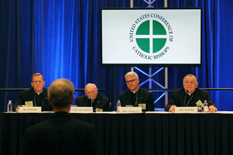 A reporter asks a question during a news conference on Tuesday (Nov. 11, 2014) during the annual fall general assembly of the U.S. Conference of Catholic Bishops in Baltimore. Pictured left to right is Bishop John C. Wester of Salt Lake City, Cardinal Theodore E. McCarrick, retired archbishop of Washington, Archbishop Paul S. Coakley of Oklahoma City, chairman of the Catholic Relief Services board, and Miami Archbishop Thomas G. Wenski. Photo by Bob Roller, courtesy of Catholic News Service