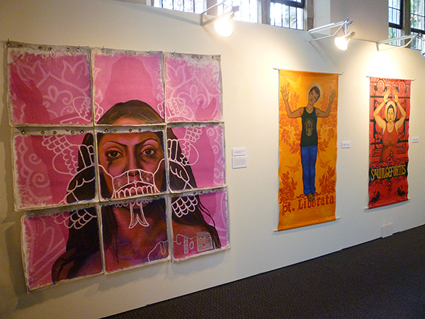 Three works by artist Alma Lopez in her show, "Queer Santas: Holy Violence" on display at Pacific School of Religion. Religion News Service photo by Kimberly Winston