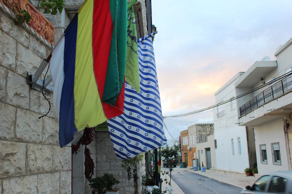 Druze and Israel flags flying next to each other in Daliyat al-Carmel. Photo courtesy of Ben Hartman