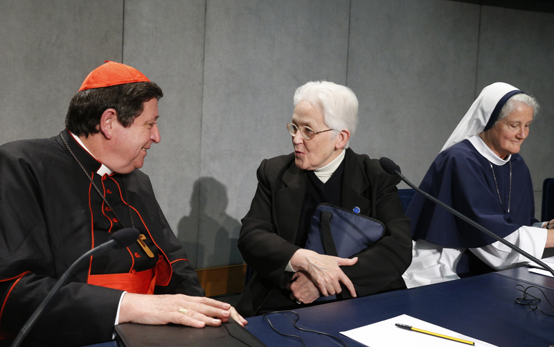 Brazilian Cardinal Joao Braz de Aviz, prefect of the Congregation for Institutes of Consecrated Life and Societies of Apostolic Life, speaks with Sister Sharon Holland, center, president of the Leadership Conference of Women Religious, at the conclusion of a Vatican press conference for release of the final report of a Vatican-ordered investigation of U.S. communities of women religious on Tuesday, December 16, 2014. Also pictured is Sister Agnes Mary Donovan, far right, coordinator of the Council of Major Superiors of Women Religious. Photo by Paul Haring, courtesy of Catholic News Service