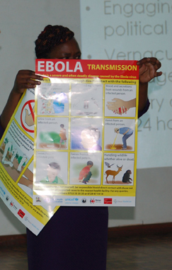 (RNS) The Rev. Pauline Njiru of Kenya displays a poster showing how Ebola can be transmitted. RNS Photo by Fredrick Nzwili