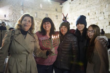 More than 100 women, including comedian Sarah Silverman, second from right, participated in the first-ever Hanukkah candle lighting in the women's section of the Western Wall. RNS photo courtesy Women of the Wall.