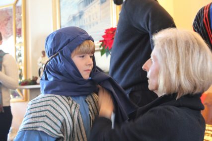 Gabriel Ross, left, prepares to portray the drummer boy in the Live Nativity of the Faith and Action ministry in Washington, D.C., on Dec. 11, 2014. His grandmother, Gwen Ross, assisted members of Midway Assembly of God in Lewes, Del., who played characters in the presentation. Religion News Service photo by Adelle M. Banks