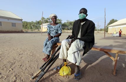 An injured man and woman who were displaced as a result of Boko Haram attacks in the northeast region of Nigeria, sit on a bench at a camp for internally displaced persons (IDP) in Yola, Adamawa State on January 13, 2015. Photo courtesy of REUTERS/Afolabi Sotunde  *Note: This photo may only be republished with RNS-BOKO-HARAM, originally published on January 23, 2015