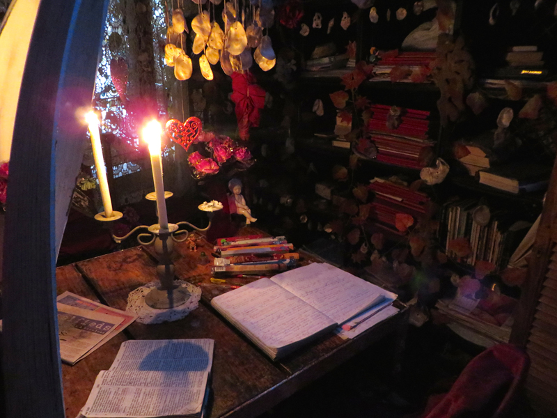 Clifford Brandon reads the Bible every day in “Father’s Room,” a candlelit space at the grotto’s heart, which doubles as his writing room. Religion News Service photo by Brian Pellot