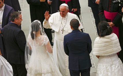 Pope Francis waves to newlywed couples during his Wednesday general audience in Paul VI hall at the Vatican on Wednesday (January 21, 2015). Photo courtesy of REUTERS/Tony Gentile *Note: This photo may only be used with RNS-POPE-FAMILIES, published on January 21, 2015