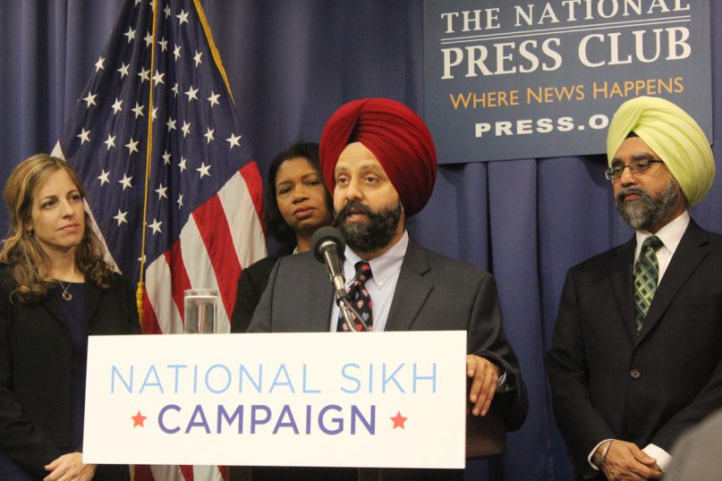 Rana Sodhi, brother of Baldir Singh Sodhi, a Sikh man who was shot and killed on Sept. 15, 2001, speaks at a news conference of the National Sikh Campaign at the National Press Club in Washington on Jan. 26, 2015. Behind him, left to right, are Rachel Laser of the Religious Action Center of Reform Judaism, the Rev. Leslie Copeland-Tune of Grace and Race Ministries, and Rajwant Singh of the National Sikh Campaign. Religion News Service photo by Adelle M. Banks