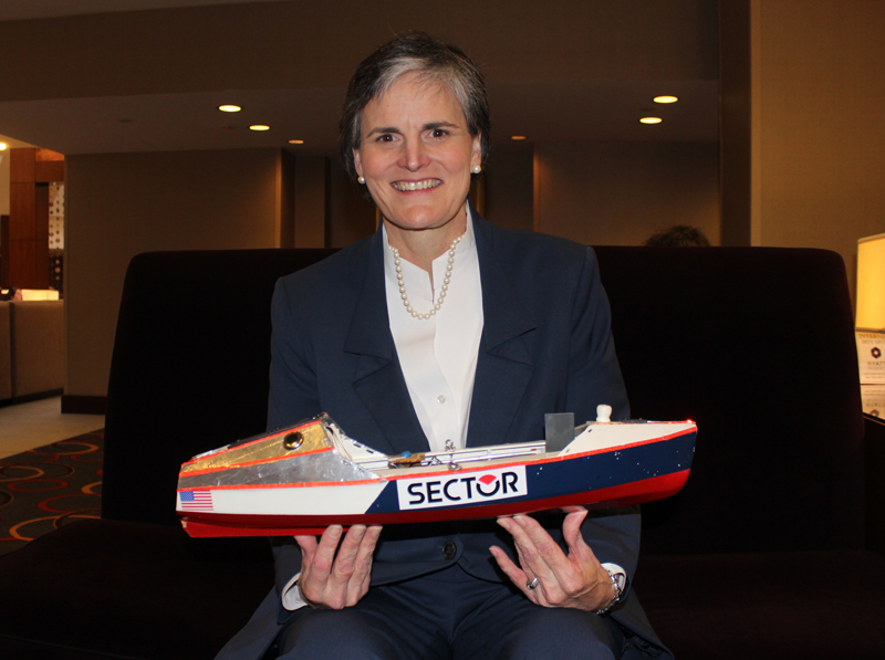 Tori Murden McClure, president of Spalding University in Louisville, Ky., poses with a replica of the rowboat she used in 1999 to become the first woman to row alone across the Atlantic Ocean. She had just spoken to fellow presidents of the National Association of Independent Colleges and Universities in Washington, D.C., on Feb. 4, 2015. Religion News Service photo by Adelle M. Banks