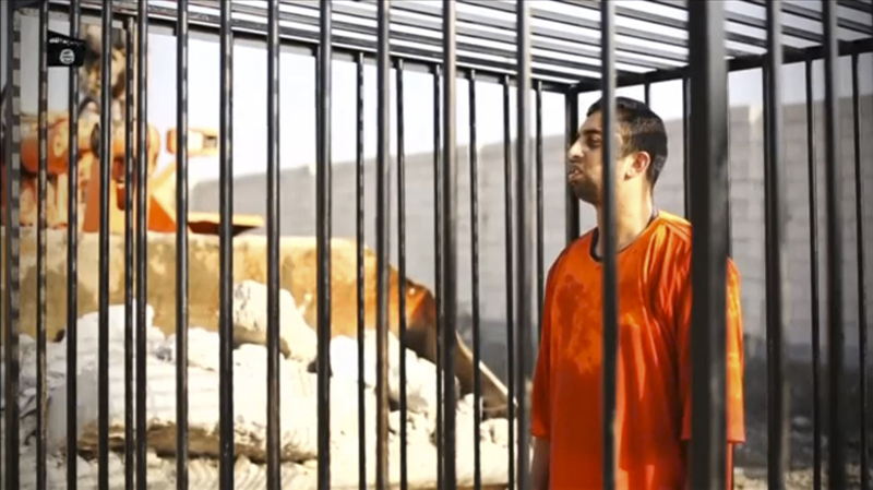 A man purported to be Islamic State captive Jordanian pilot Muath al-Kasaesbeh is seen standing in a cage in this still image from an undated video filmed from an undisclosed location made available on social media on February 3, 2015. Islamic State militants released the video on Tuesday purporting to show Kasaesbeh being burnt alive, and Jordanian state television said he was murdered a month ago. Reuters could not immediately confirm the video, which showed a man resembling the captive pilot standing in a black cage before being set ablaze. Photo courtesy of REUTERS/Social media via Reuters TV 