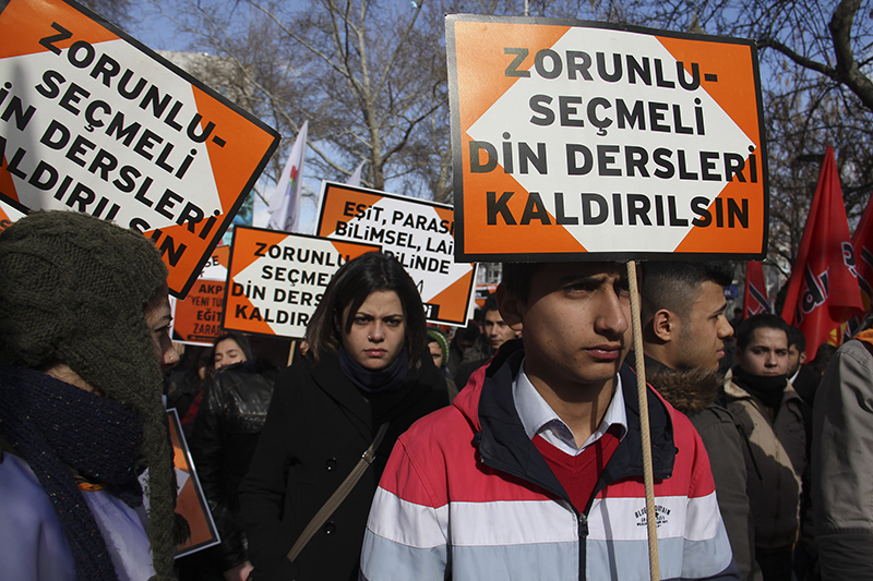 A Turkish demonstrator carries a placard reading 