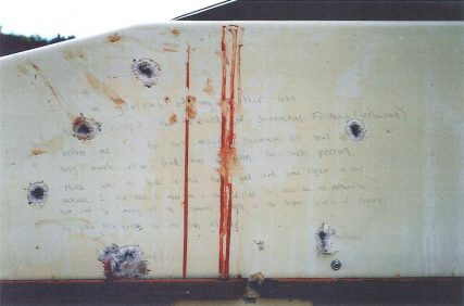 A blood-stained message that prosecutors say Boston Marathon bombing suspect Dzhokhar Tsarnaev wrote on the inside of a boat is seen with bullet holes.  Tsarnaev, 21, is accused of killing three people and injuring 264 with a pair of homemade bombs at the race's crowded finish line on April 15, 2013, as well as fatally shooting a police officer three days later.    REUTERS/U.S. Department of Justice/Handout via Reuters  