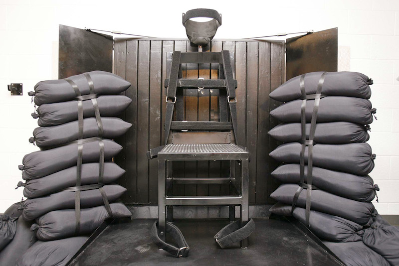 The execution chamber at the Utah State Prison is seen after Ronnie Lee Gardner was executed by a firing squad in Draper June 18, 2010. Four bullet holes are visible in the wood panel behind the chair. Photo courtesy REUTERS/Trent Nelson-Salt Lake Tribune/Pool
HIGH RES: http://archives.religionnews.com/multimedia/photos/rns-utah-death