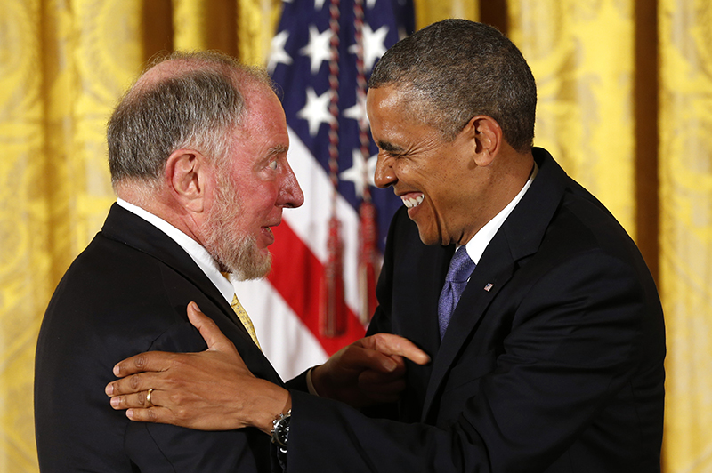  U.S. President Barack Obama laughs with political scientist Robert Putnam before awarding him the 2012 National Humanities Medal during a ceremony at the White House in Washington on July 10, 2013. Photo courtesy of REUTERS/Kevin Lamarque *Editors: This photo may only be republished with RNS-PUTNAM-BOOK, originally transmitted on March 19, 2015.