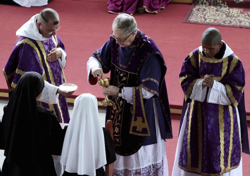 French Bishop Jean-Michel Faure (2nd R) gives holy communions during a mass in Nova Friburgo near Rio de Janeiro on March 28, 2015. Photo by Stephen Eisenhammer, courtesy of Reuters.
HIGH RES: http://archives.religionnews.com/multimedia/photos/rns-french-bishop
