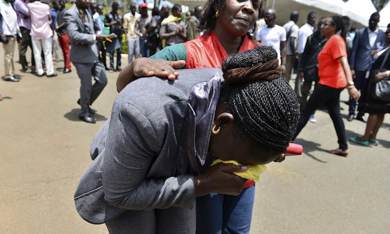A Red Cross worker comforts a mourner as bodies of the students killed in a Thursday (April 2) attack, arrive at the Chiromo Mortuary in Nairobi. The assault by Somali militants killed 148 people on a Kenyan university, as anger grew among local residents over what they say was a government failure to prevent bloodshed.  
REUTERS/Herman Kariuki
*Editors: This photo may only be republished with RNS-PERSECUTION-ENVOY, originally transmitted on April 23, 2015.