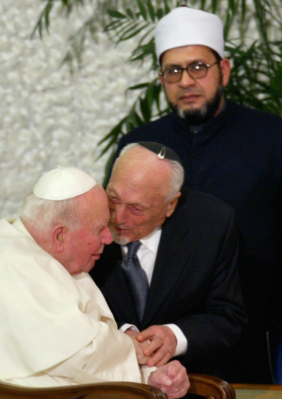 Pope John Paul II chats with emeritus Rabbi of Rome Elio Toaff as Abdulawahab Hussein Gomaa, Iman of Rome Mosque, looks on behind them at the end of the Concert of Reconciliation in Paul VI Hall at the Vatican Jan. 17, 2004. Photo by REUTERS/Max Rossi.